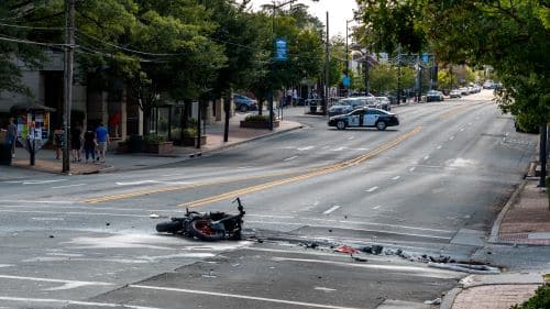 A motorcycle lies in an intersection after an accident.