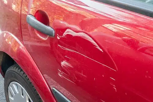 Car Side panel has dent after Sideswipe Car Accident