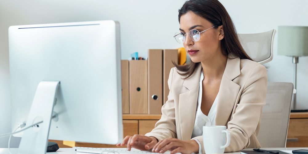 Billing specialist managing no-fault claim documents on a computer